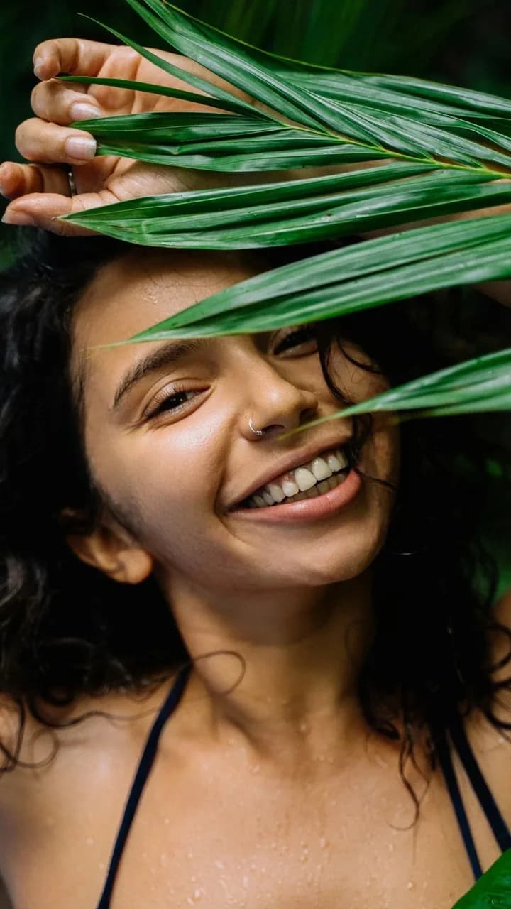 The same portrait after one-click AI skin retouching, skin texture kept